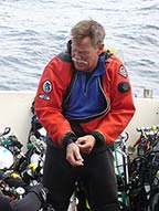 Tech diver donning drysuit